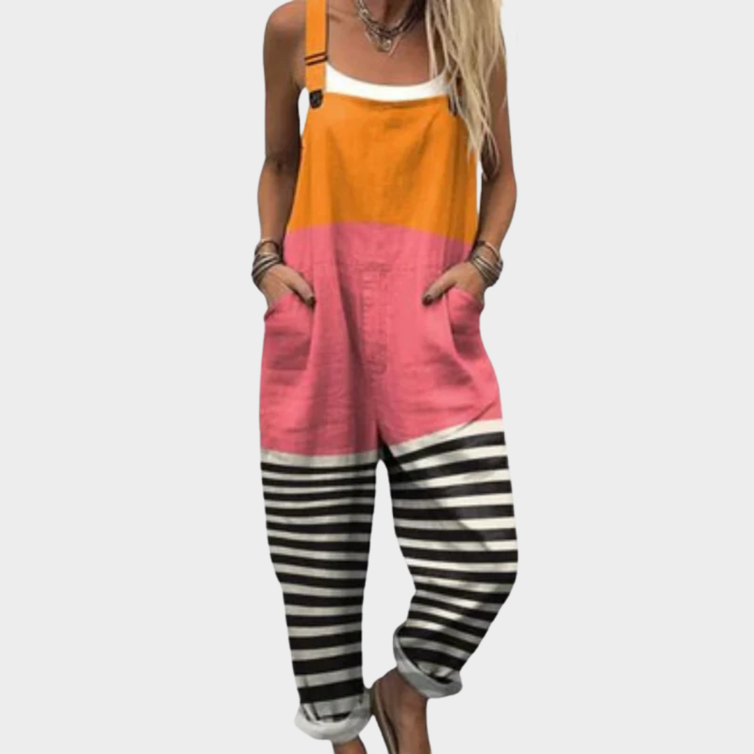 Woman wearing colour-block overalls in orange and pink with black-and-white striped legs