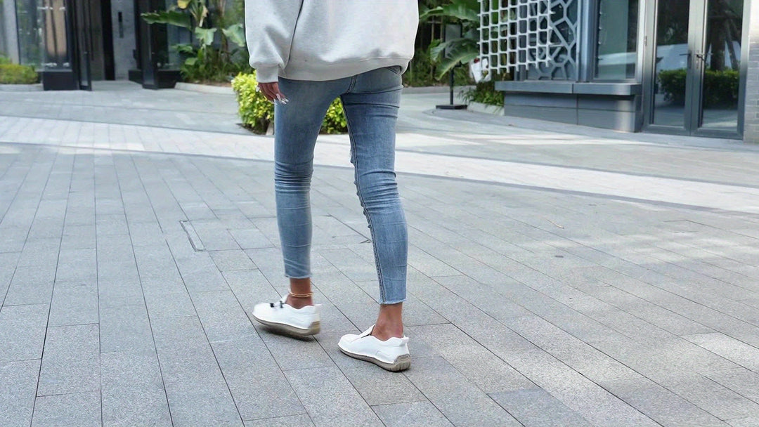 A woman walking smoothly in soft, supportive therapeutic walking shoes.