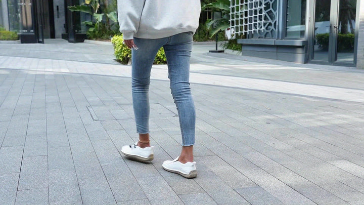 A woman walking smoothly in soft, supportive therapeutic walking shoes.
