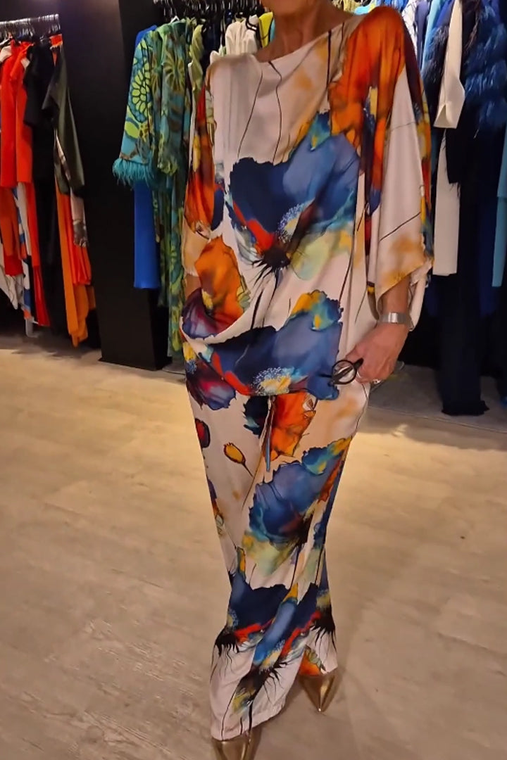 A woman wearing a bold floral print two-piece set with a loose flowing fit, vibrant and elegant.