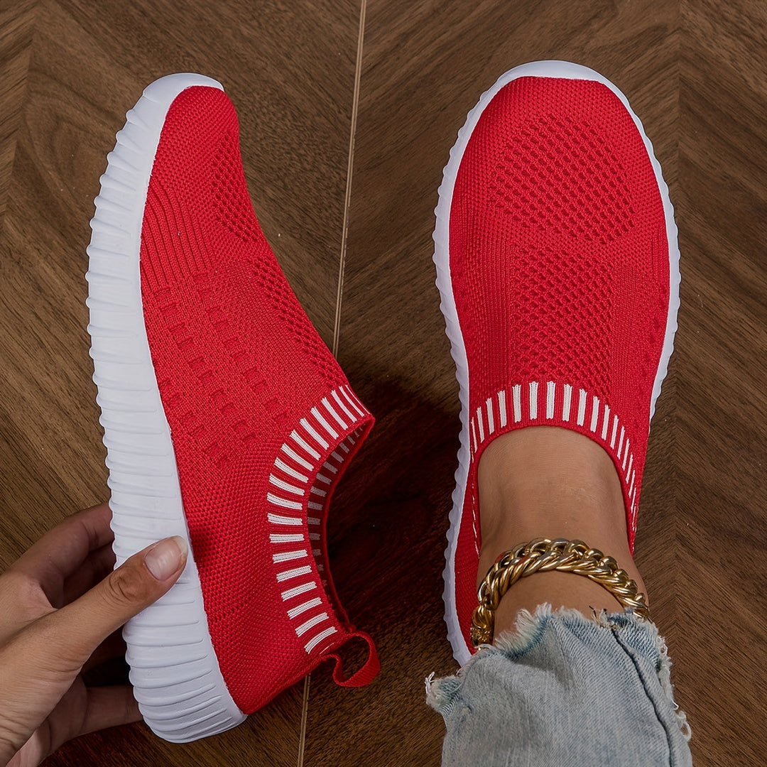 A woman slipping on ultralight sock-style sneakers that hug the foot.