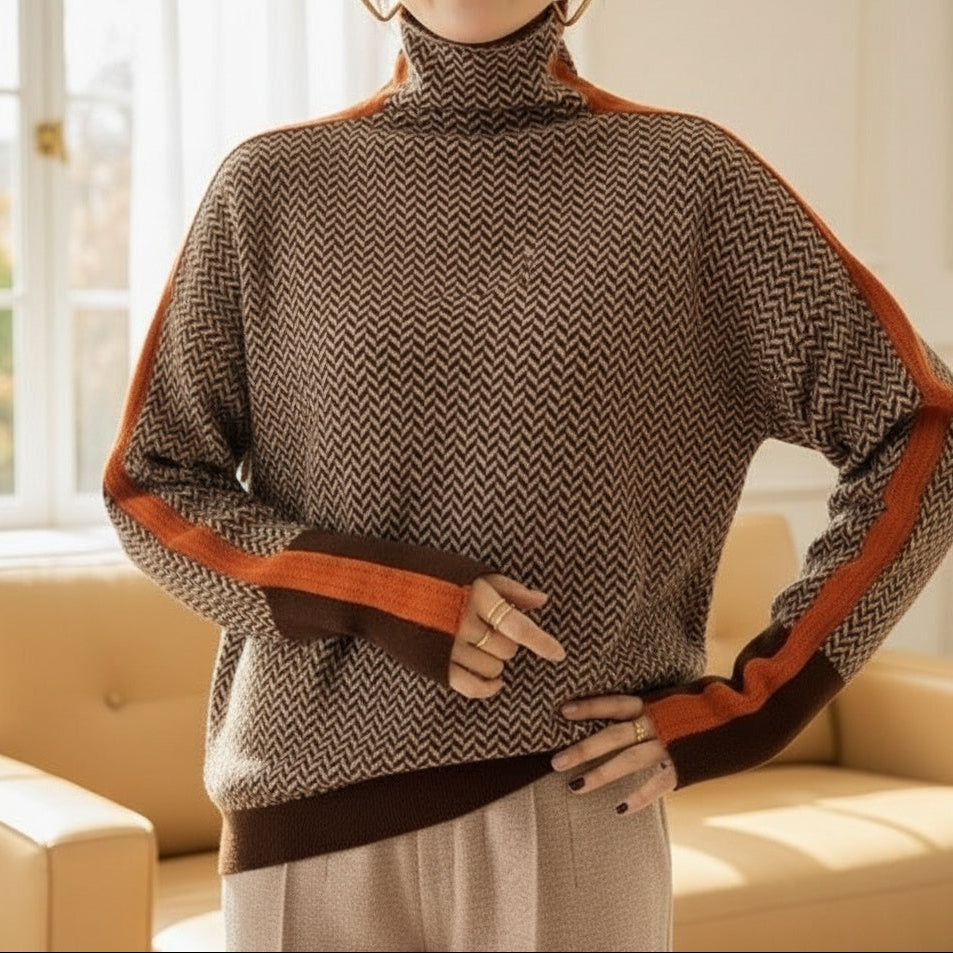 A woman wearing a brown and beige chevron high-collar sweater with bright green side stripes.