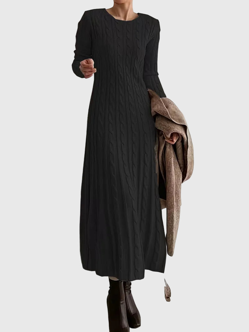 Woman wearing the Emily cable-texture maxi dress in soft cream, styled with boots.