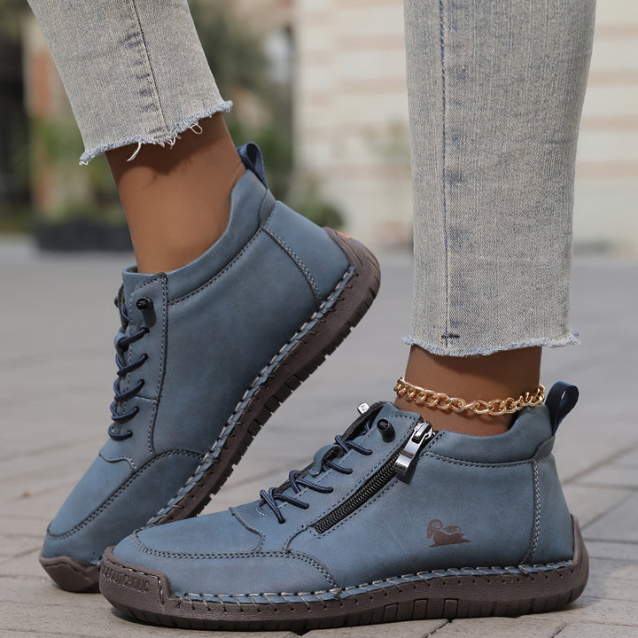A woman standing comfortably in wide-fit therapeutic comfort shoes