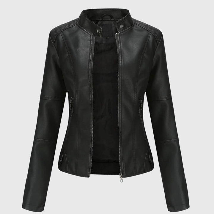 A woman wearing a fitted black moto jacket with a supple finish, styled for an evening out.