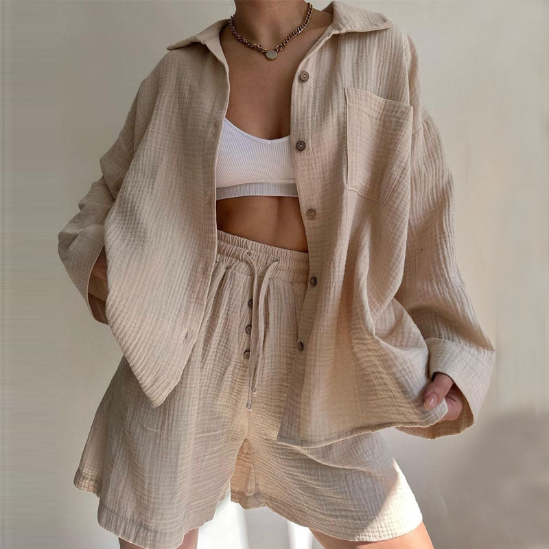 A woman wearing a flowing oversized shirt with drawstring shorts, relaxed and breezy.
