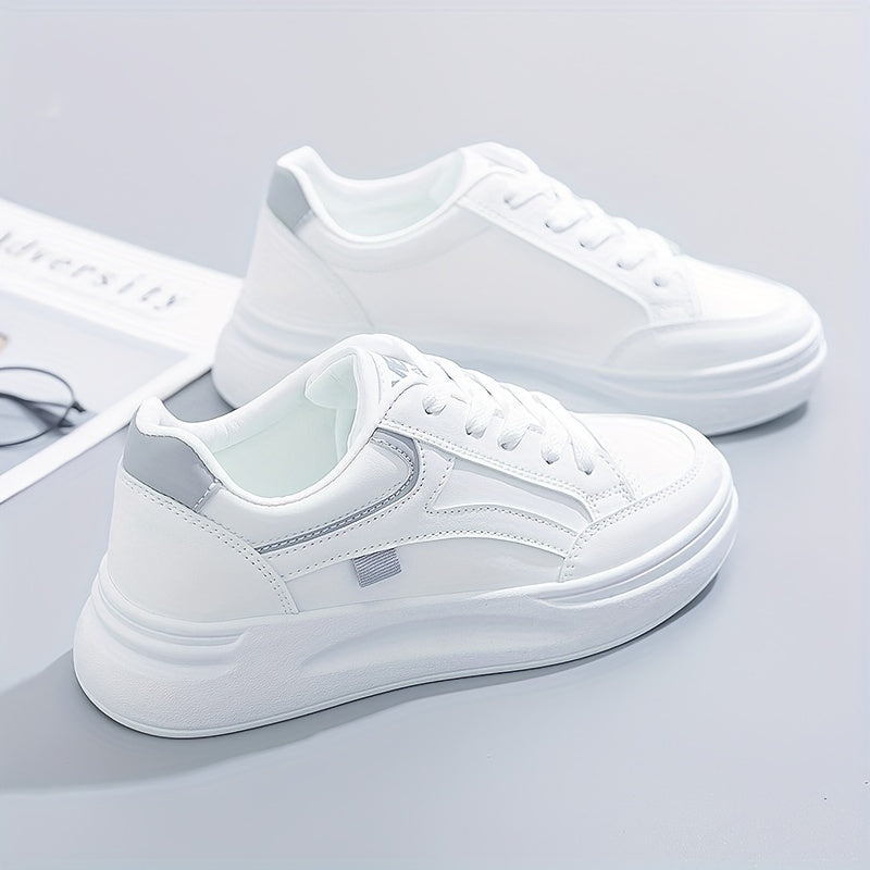 A woman in crisp white light comfort sneakers paired with jeans.