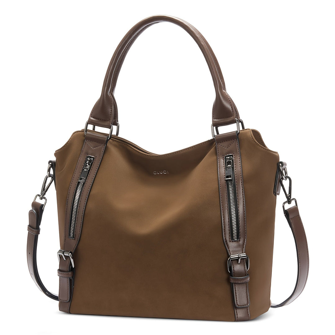 A woman wearing a roomy shoulder bag across her body while out running errands.