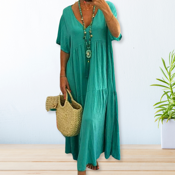 Woman wearing a relaxed V-neck maxi dress with a soft, flowing drape.
