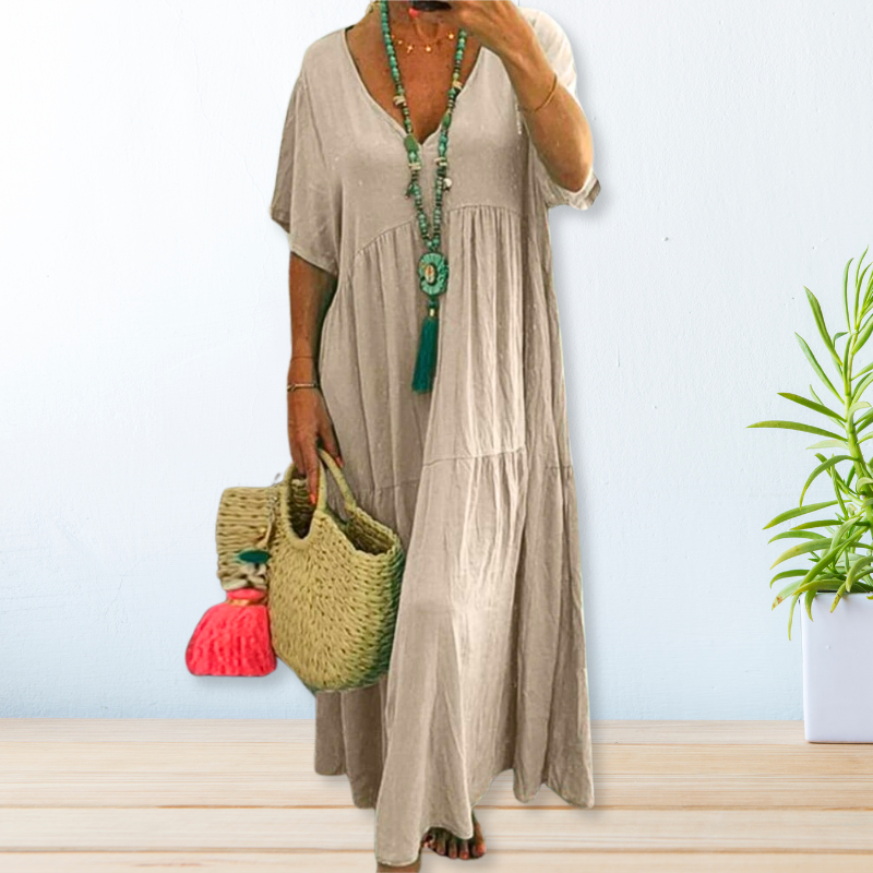 Woman wearing a relaxed V-neck maxi dress with a soft, flowing drape.