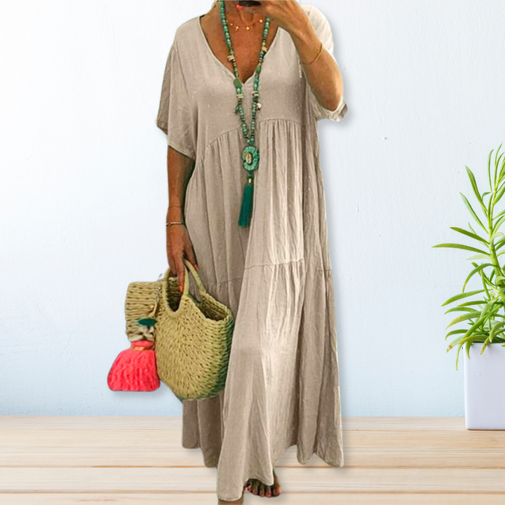 Woman wearing a relaxed V-neck maxi dress with a soft, flowing drape.