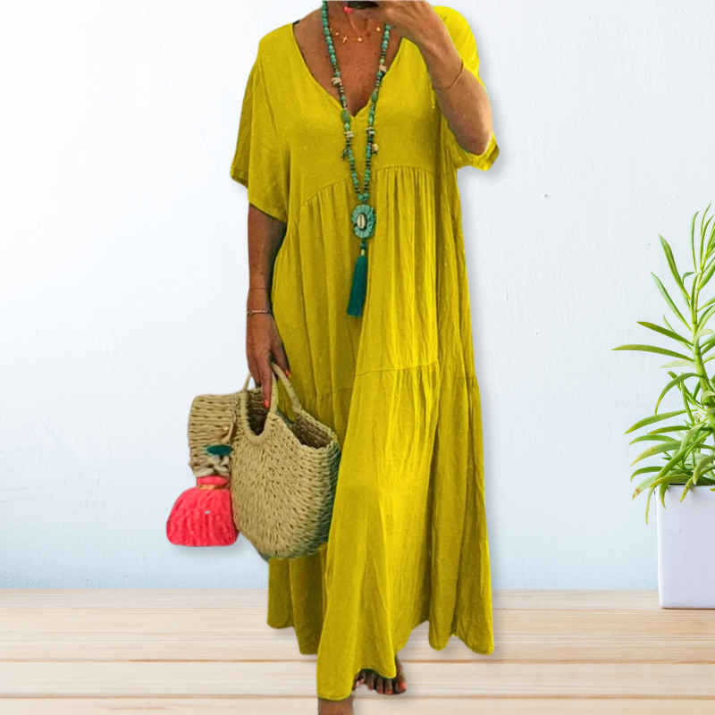 Woman wearing a relaxed V-neck maxi dress with a soft, flowing drape.