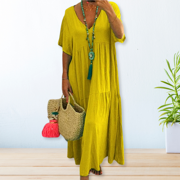 Woman wearing a relaxed V-neck maxi dress with a soft, flowing drape.