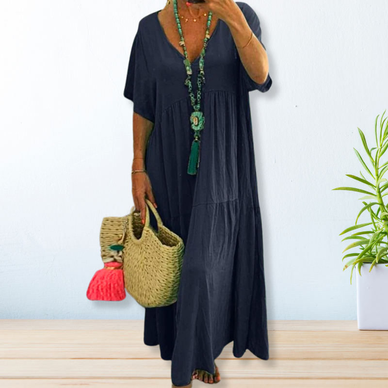 Woman wearing a relaxed V-neck maxi dress with a soft, flowing drape.