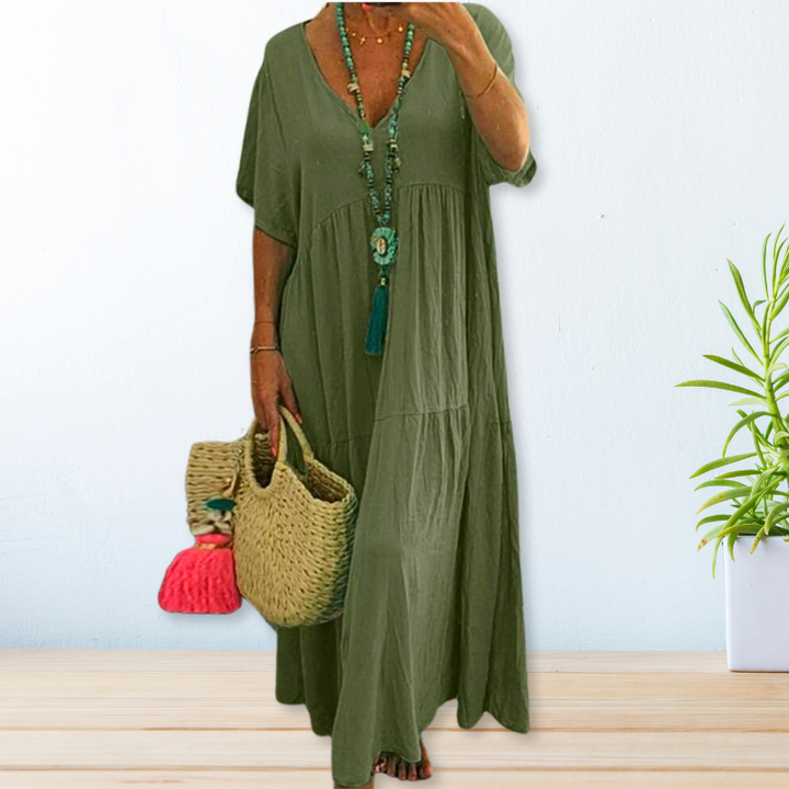 Woman wearing a relaxed V-neck maxi dress with a soft, flowing drape.