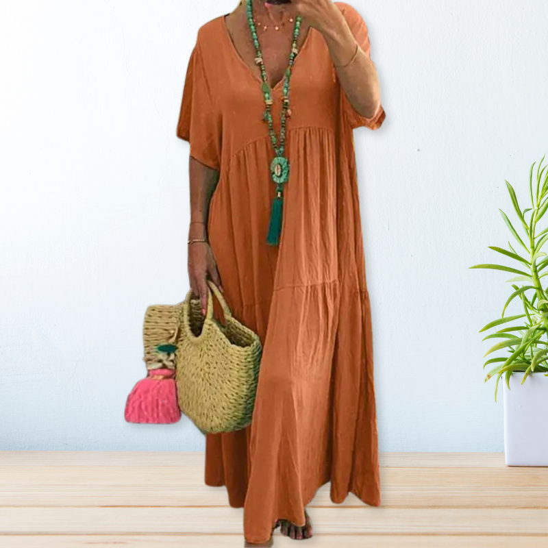 Woman wearing a relaxed V-neck maxi dress with a soft, flowing drape.