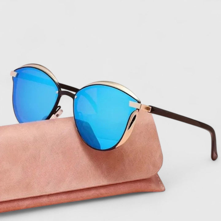 A woman wearing minimalist polarised gradient sunglasses on a bright day.