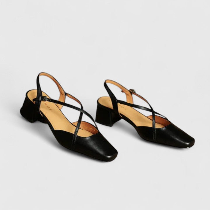 Burgundy closed square-toe flats with criss-cross instep straps and a buckled slingback.