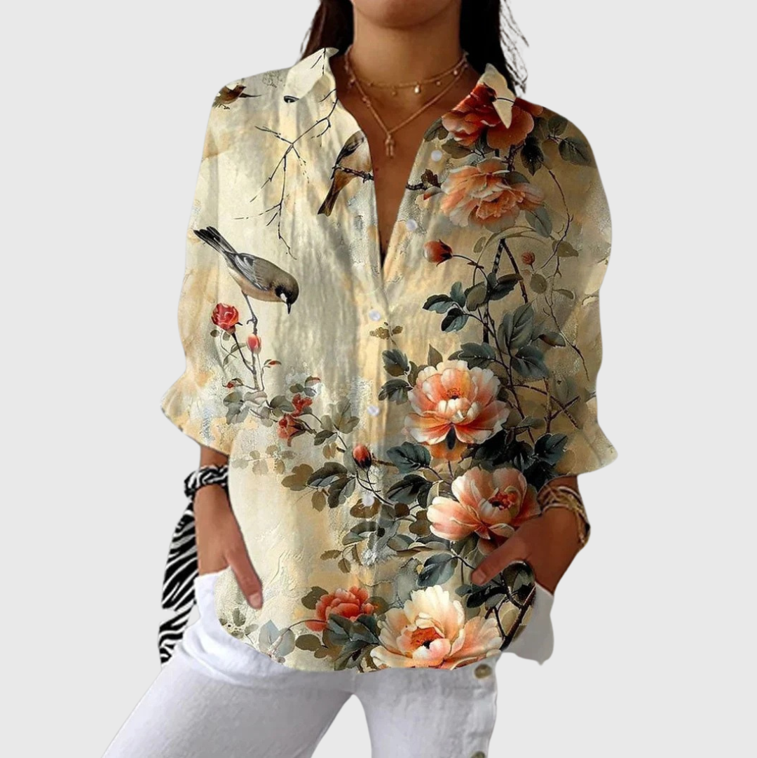 A woman wearing a relaxed colourful printed blouse with an elegant button placket, comfortable and bright on a day out.