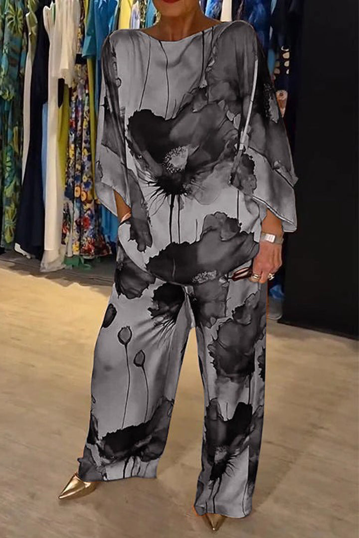 A woman wearing a bold floral print two-piece set with a loose flowing fit, vibrant and elegant.