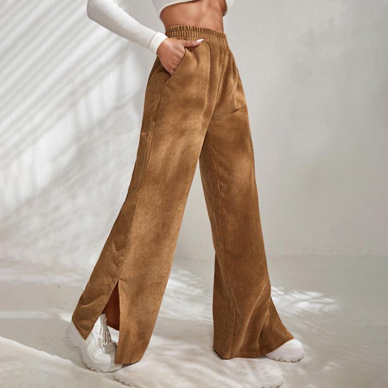 Woman wearing wide-leg ribbed joggers with a fitted top, relaxed at home.