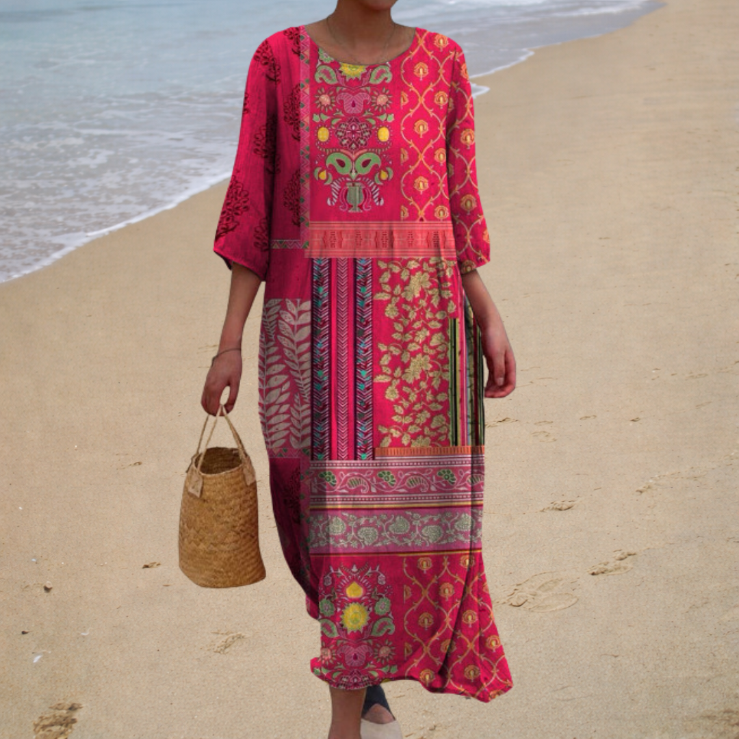 A woman wearing a long, flowing patterned maxi dress that drifts as she walks.