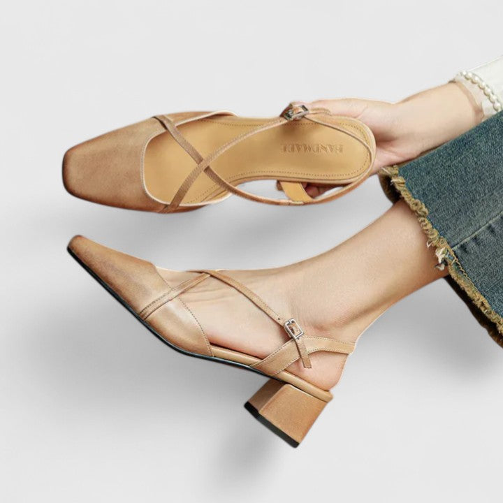 Burgundy closed square-toe flats with criss-cross instep straps and a buckled slingback.