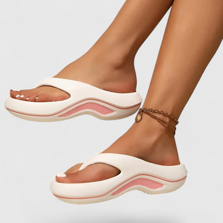 A woman in white slip-on sandals stepping out lightly, feet cushioned and supported.