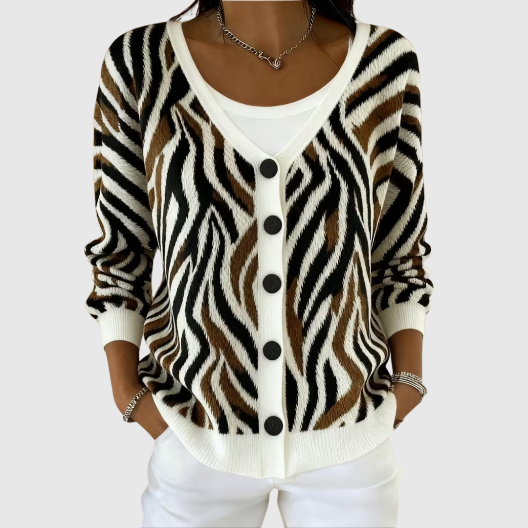 A woman wearing a soft button cardigan open over a top, relaxed and neat