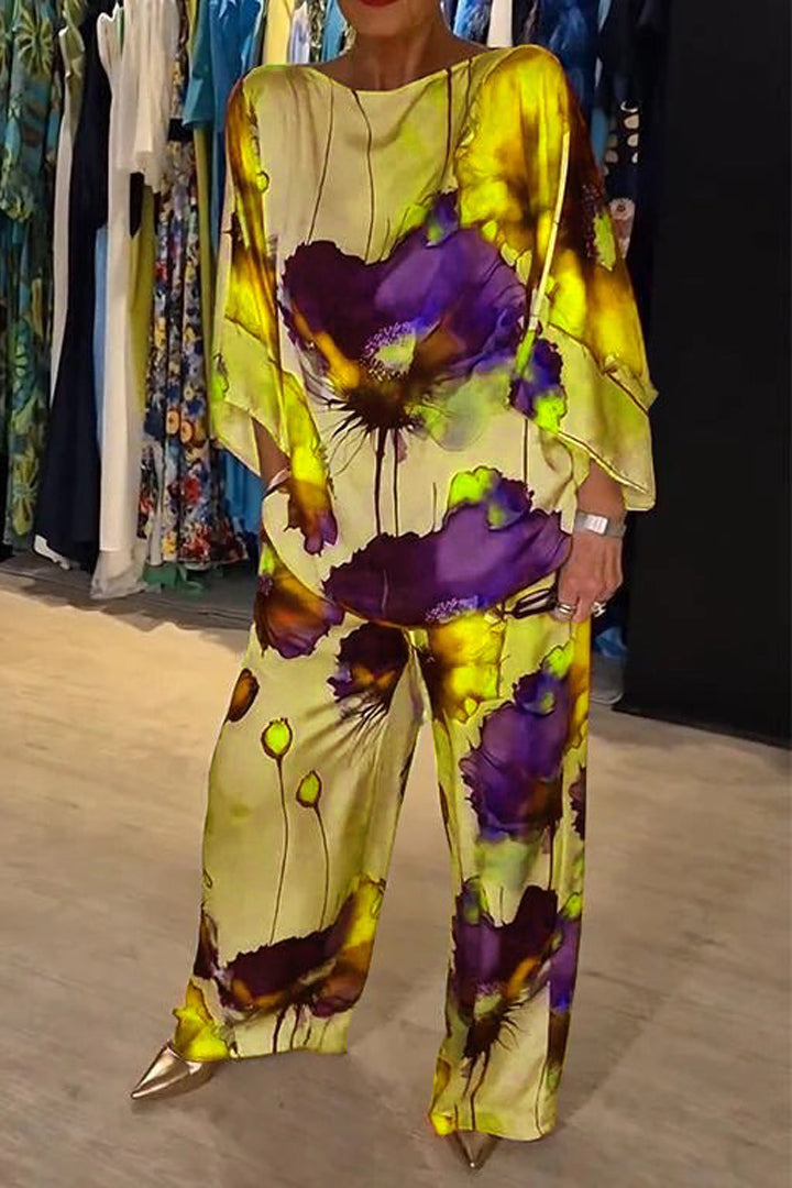 A woman wearing a bold floral print two-piece set with a loose flowing fit, vibrant and elegant.