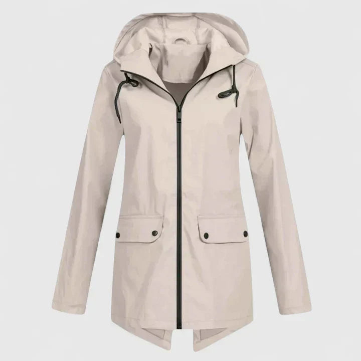 A woman wearing a hooded rain jacket, walking outdoors in light rain