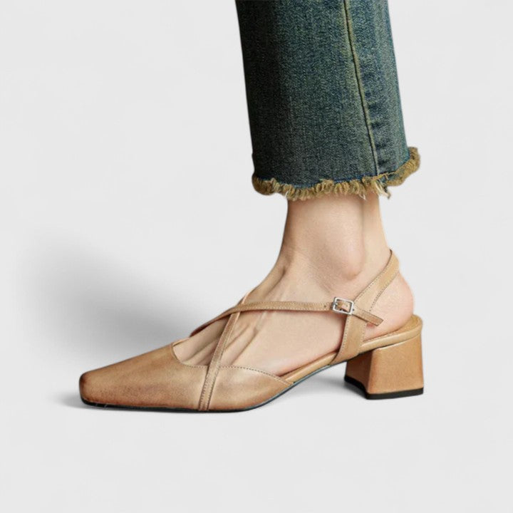 Burgundy closed square-toe flats with criss-cross instep straps and a buckled slingback.