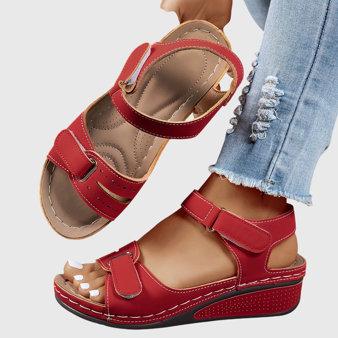 A woman wearing wide-fit supportive sandals with a relaxed summer outfit, walking with ease and confidence.