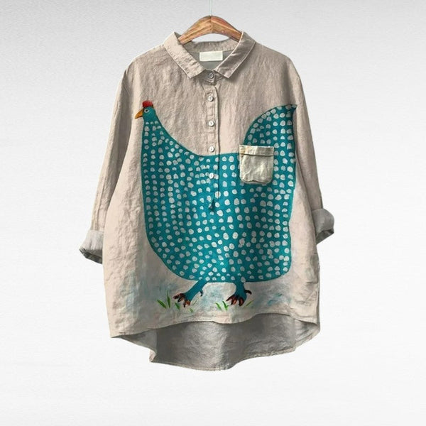 A woman wearing a light patterned summer blouse on a warm evening