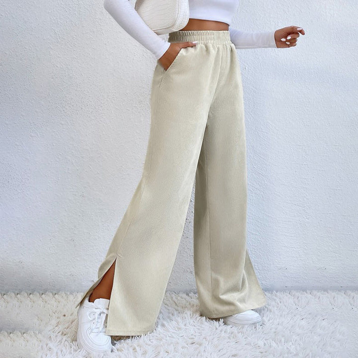 Woman wearing wide-leg ribbed joggers with a fitted top, relaxed at home.