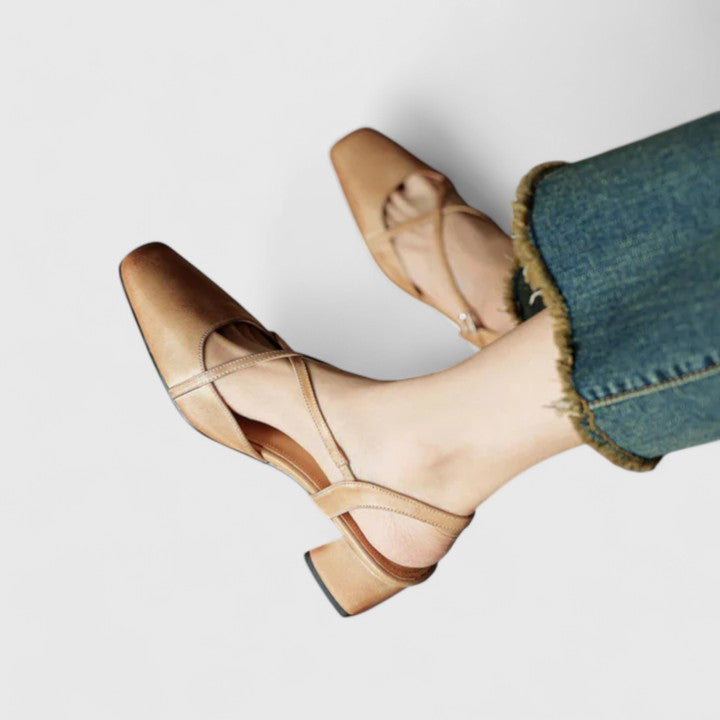 Burgundy closed square-toe flats with criss-cross instep straps and a buckled slingback.