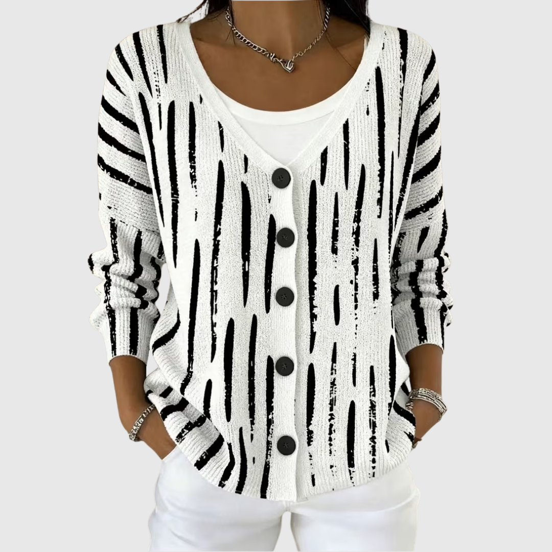 A woman wearing a classic button cardigan closed over a top, neat and relaxed