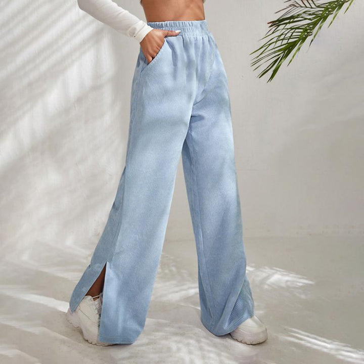 Woman wearing wide-leg ribbed joggers with a fitted top, relaxed at home.