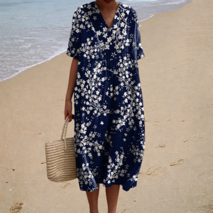 A woman wearing a comfortable loose patterned summer dress, relaxed and elegant in the warm sun.