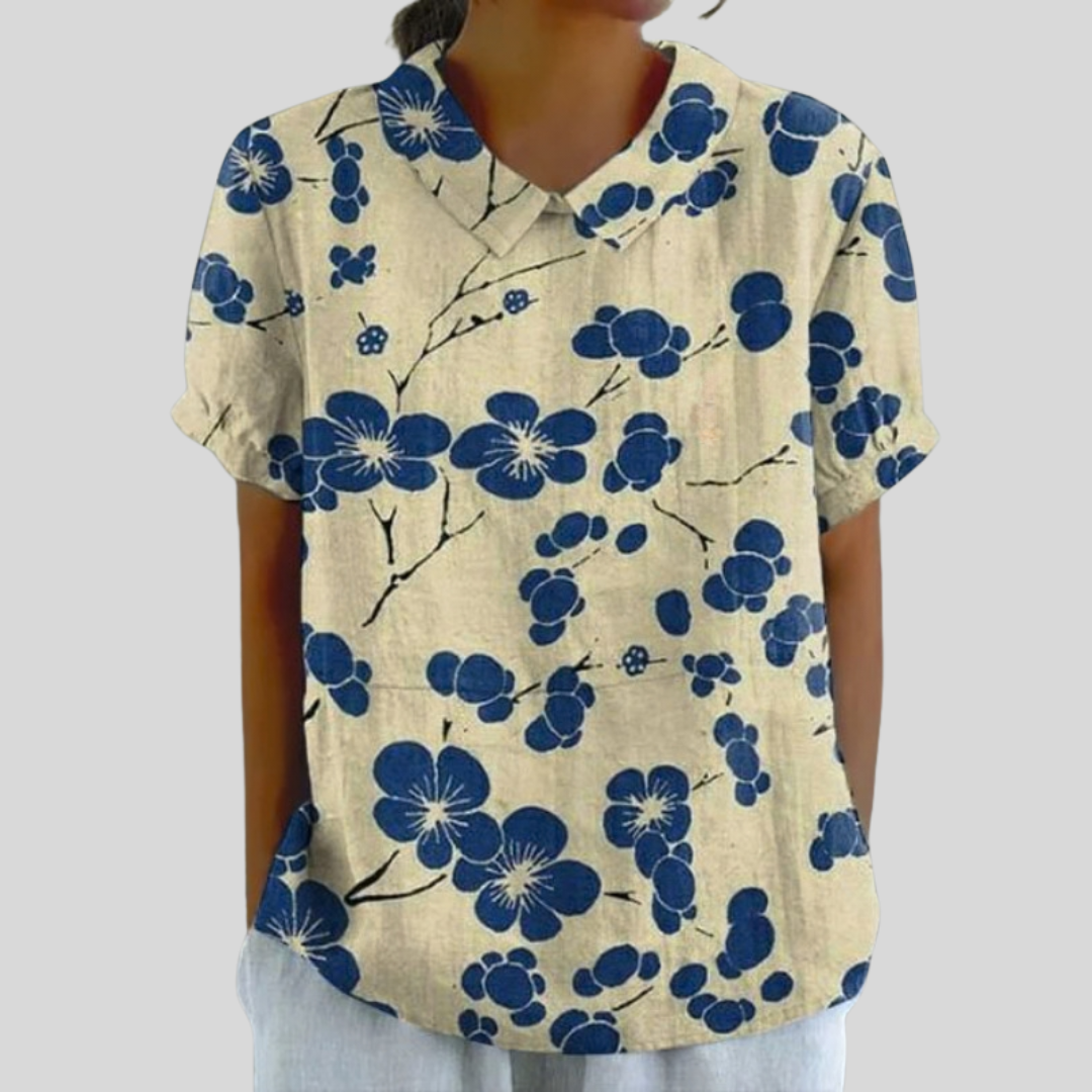 A woman wearing a floral top with a polo collar on a relaxed day out