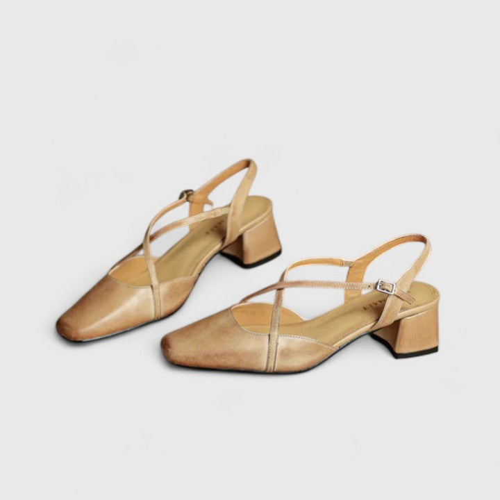 Burgundy closed square-toe flats with criss-cross instep straps and a buckled slingback.