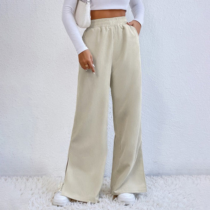 Woman wearing wide-leg ribbed joggers with a fitted top, relaxed at home.