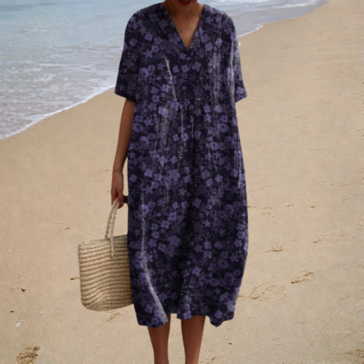 A woman wearing a comfortable loose patterned summer dress, relaxed and elegant in the warm sun.