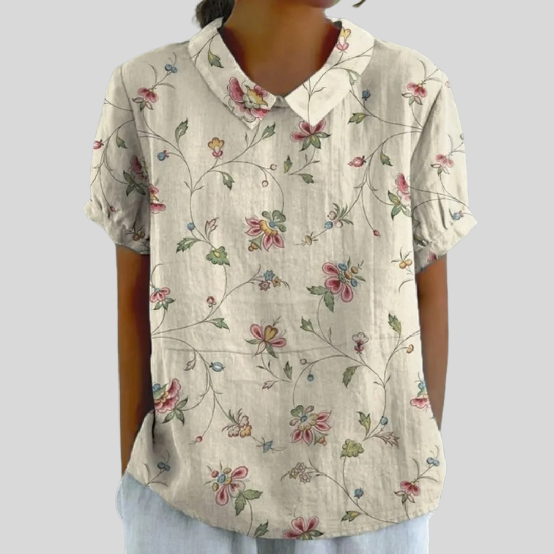 A woman wearing a floral shirt with a polo collar, comfortable and put together for the day ahead.