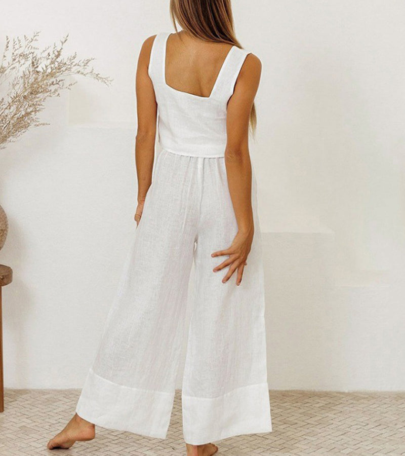 A woman wearing a minimal two-piece set with a square neckline and belted flared pants.