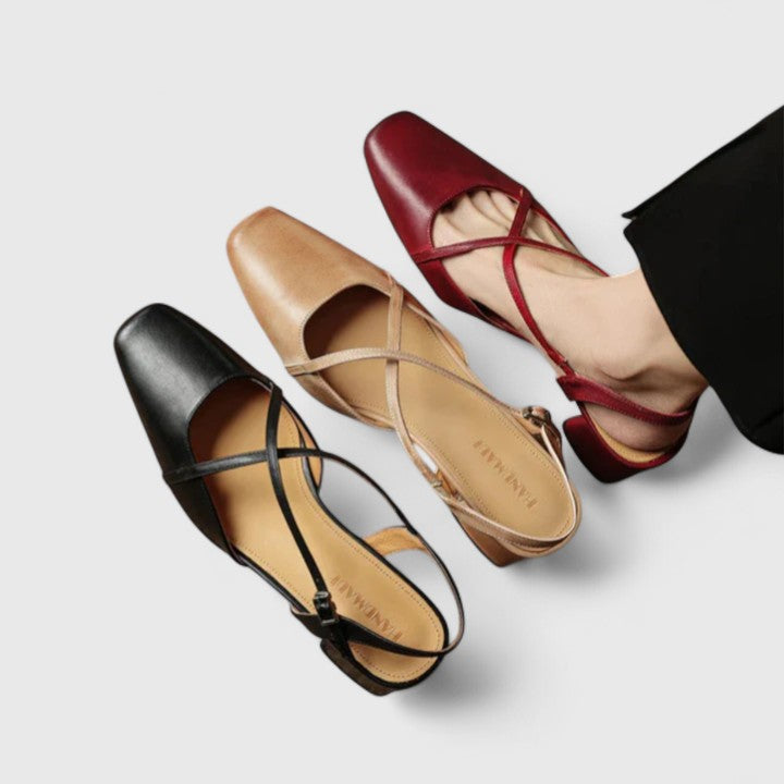 Burgundy closed square-toe flats with criss-cross instep straps and a buckled slingback.