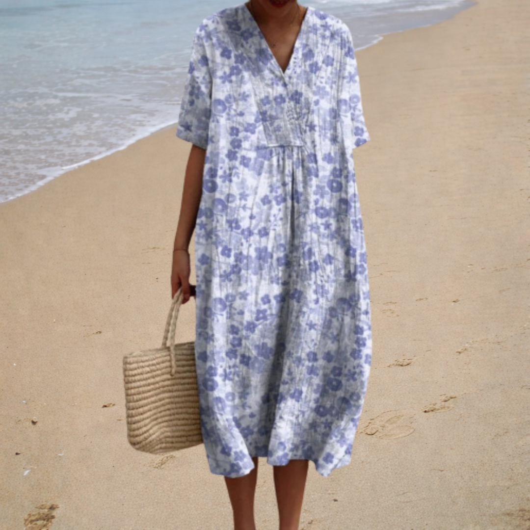 A woman wearing a comfortable loose patterned summer dress, relaxed and elegant in the warm sun.
