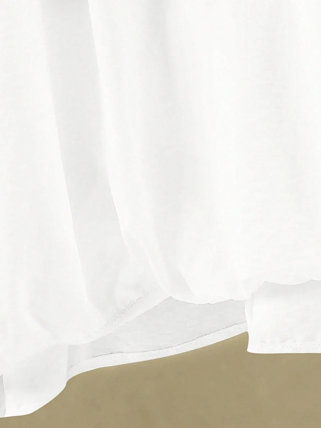 A woman wearing a flowing V-neck knot-detail top with matching flared pants.