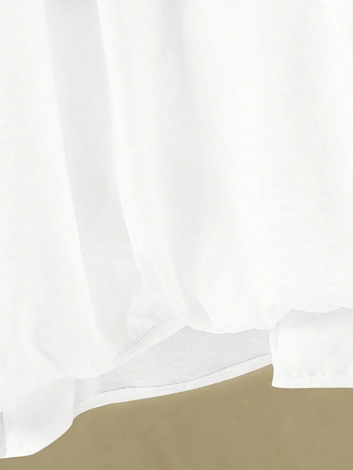 A woman wearing a flowing V-neck knot-detail top with matching flared pants.