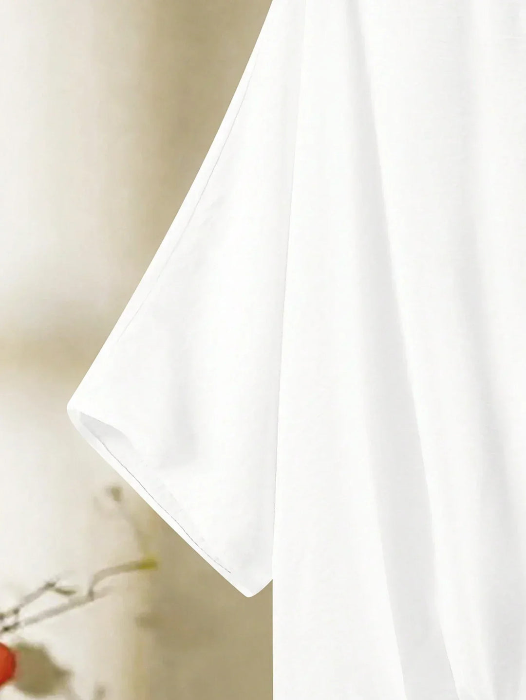 A woman wearing a flowing V-neck knot-detail top with matching flared pants.